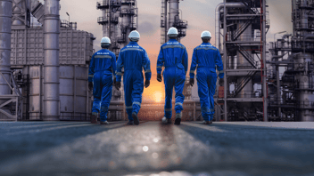 Field service specialists walking through a refinery complex during an inspection, highlighting Sulzer Chemtech's expertise in distillation tower maintenance, repairs, and performance optimization.