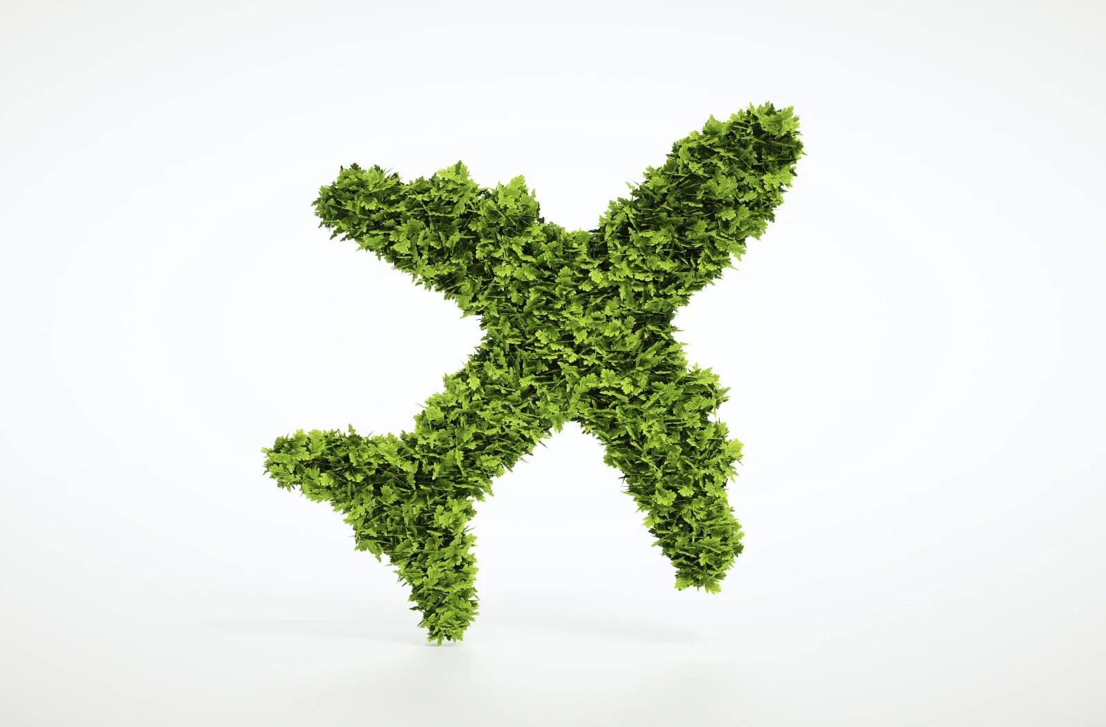 Green airplane silhouette made of leaves, symbolizing sustainable aviation fuel and the decarbonization of air transport.