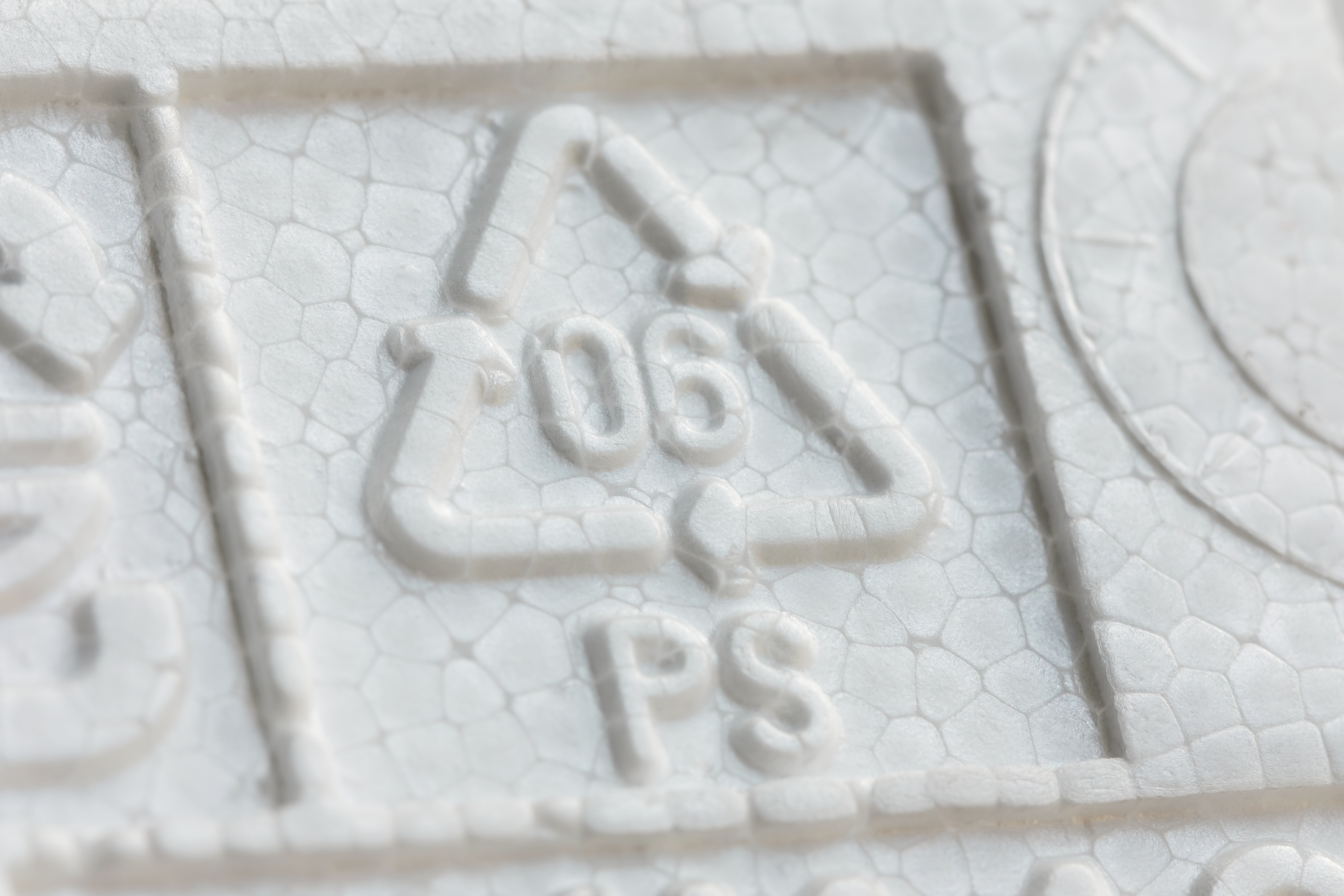 Recycled polystyrene materials moving through recovery and manufacturing processes, illustrating how flame-retardant PS can be transformed into new products as part of a circular value chain.